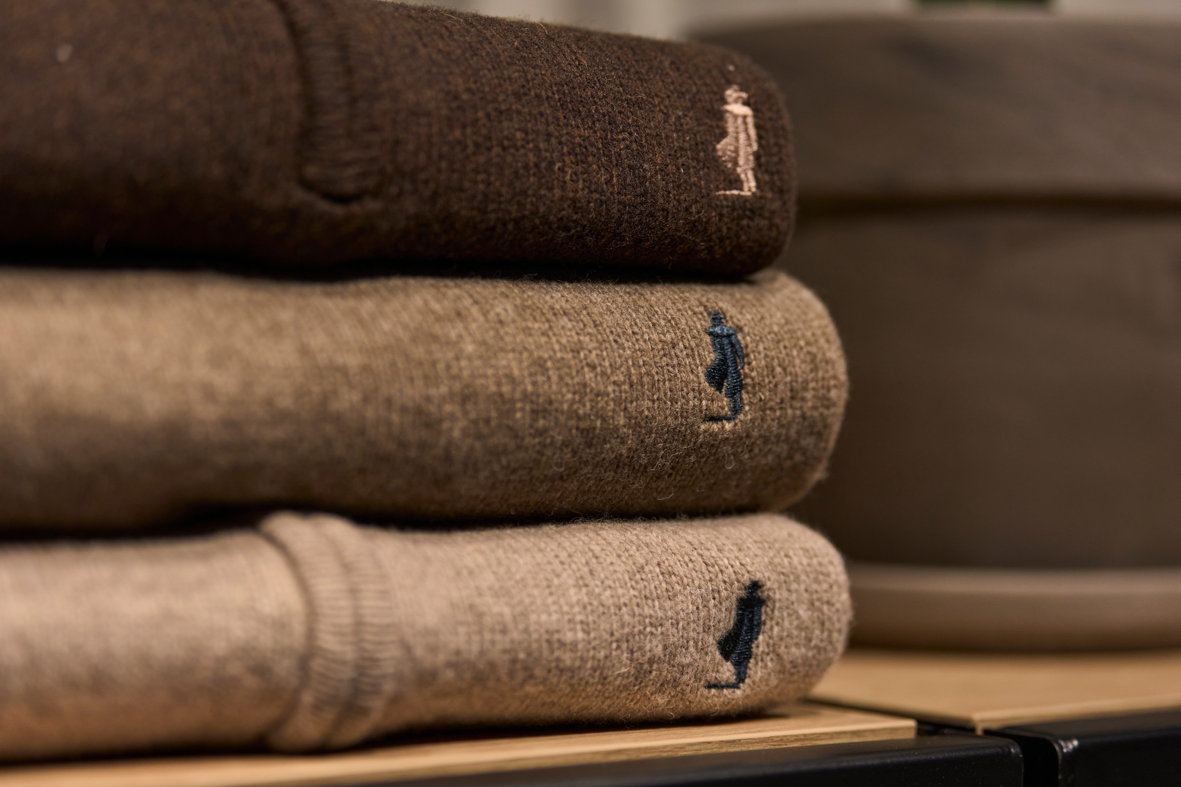 Folded sweaters with embroidered brand logos